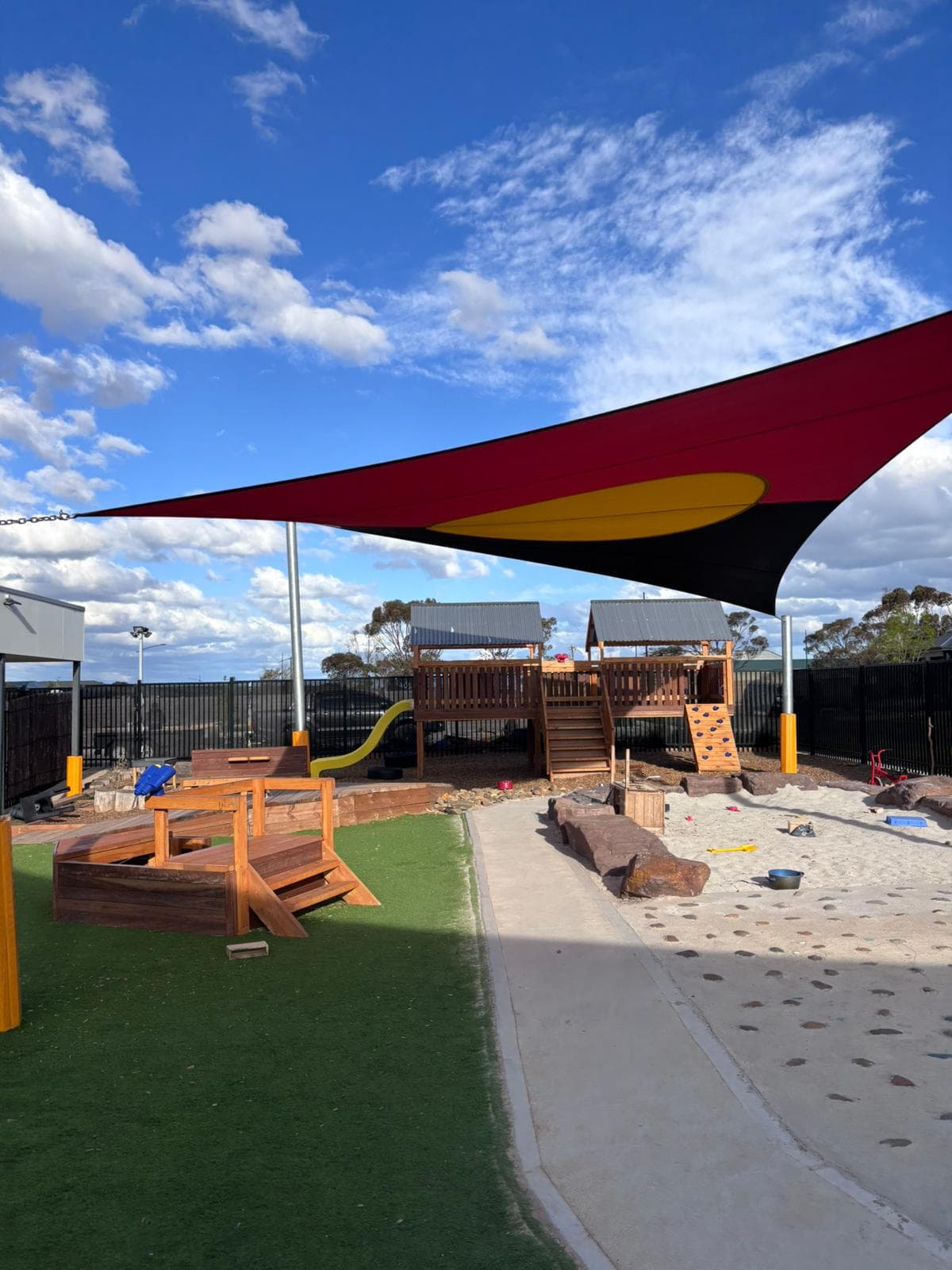 Outdoor site with shade canopy and timber features